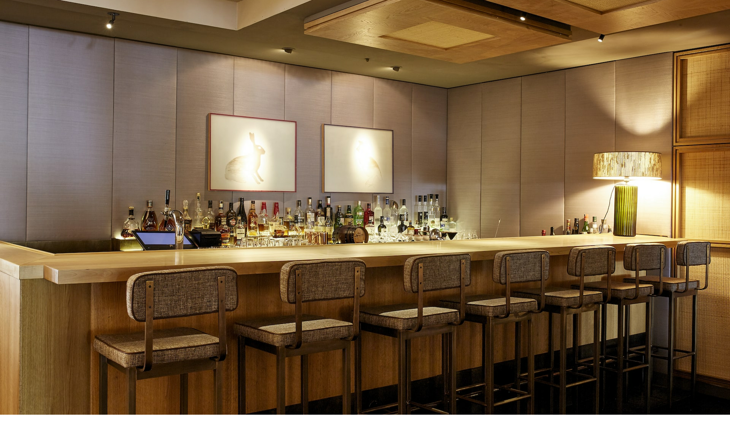 Sparkling Bar at the LOUIS Hotel Munich Elegant hotel bar with wooden counter, bar stools and stylish lighting at the LOUIS Hotel Munich.