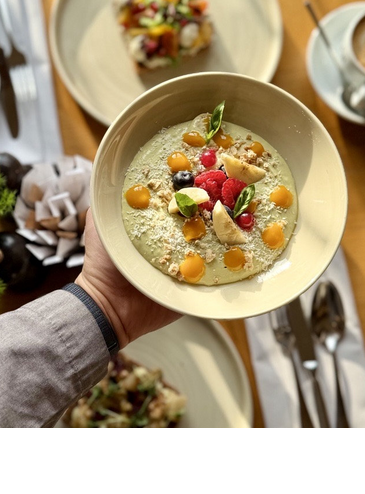 A delicious smoothie bowl with fresh fruit from the breakfast menu.